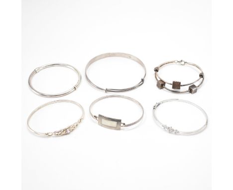 A group of 925 silver bangle bracelets. This lot to include; a hook &amp; eye mother of pearl inlay bangle (hallmarked London