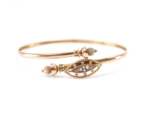 A 19th Century Victorian hallmarked 9ct gold wrap round bangle. The bangle having reeded terminals with a navette shaped head
