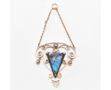 An early 20th Century Art Nouveau gold opal and seed pearl pendant. The open work pendant being set with a triangular opal to