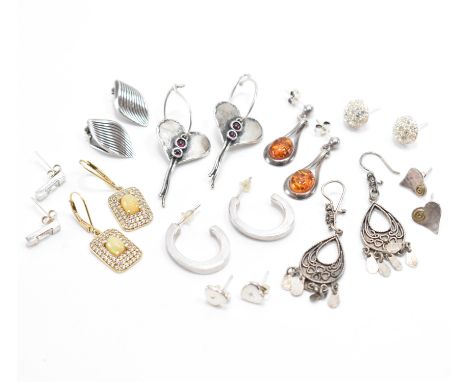 A collection of silver earrings. The lot to include; two pairs of heart studs, a pair of clip earrings, pair of stud hoops, w