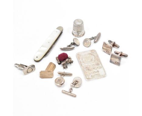 A group of silver cufflinks &amp; other items. This lot to include; frog pincushion (marked 925), a one ounce silver ingot, s