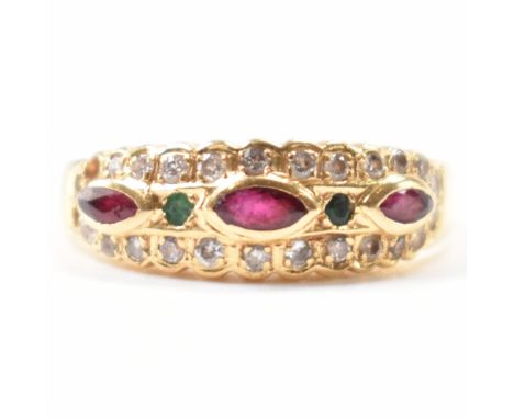 An 18ct gold, diamond, ruby & emerald ring. The ring having three navette cut bezel set rubies spaced by two round cut surfac