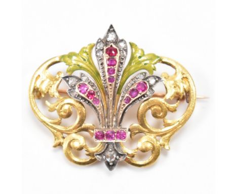 A French Art Nouveau ruby and diamond enamel brooch pin. The brooch having a fleur d lis, set with mixed cut rubies and rose 