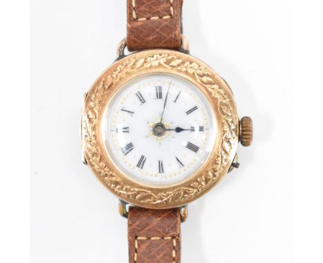 A vintage continental 14ct gold cased wrist watch. The watch having a round white enamelled face with roman numerals to the c