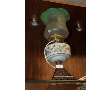 A LARGE GREEN GLASS CONVERTED OIL LAMP