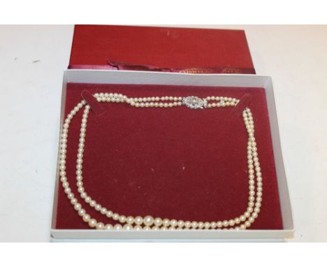 A BOXED TWO STRAND PEARL NECKLACE WITH SILVER CLASP