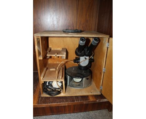 A CASED VINTAGE MICROSCOPE