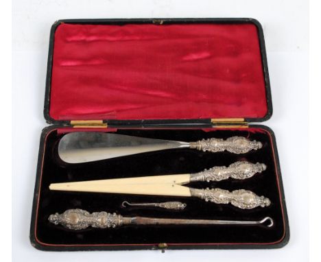 LEVI & SALAMAN;  a Victorian hallmarked silver handled dressing set comprising a pair of ivory glove stretchers with elaborat