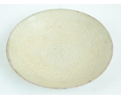 A Chinese Song dynasty ceramic circular shallow bowl mould decorated with two phoenix amongst floral and foliate sprays withi