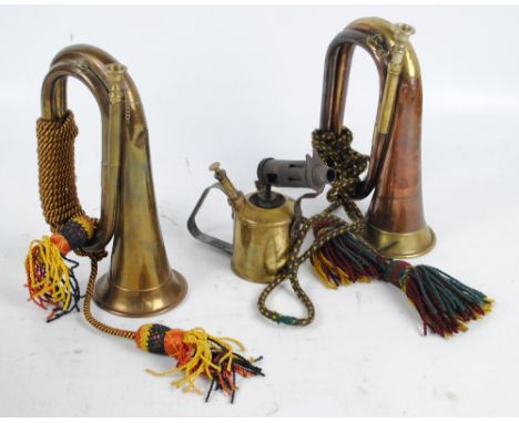 A copper and brass George Potter & Co, Aldershot bugle with coloured braid, a further brass example and a Max Sievert of Stoc