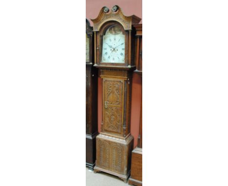 A 19th century and later carved oak longcase clock with broken swan neck pediment above arched painted dial inscribed 'Walter