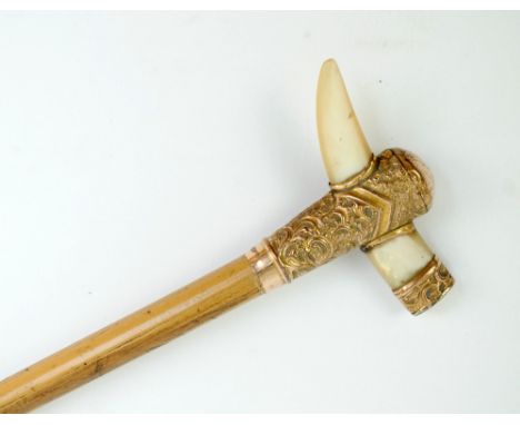 A late 19th/early 20th century bamboo swagger stick with embossed gold plated handle, decorated with mother of pearl fang, le