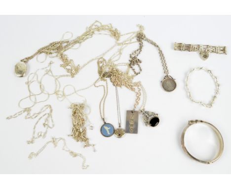 A quantity of predominantly sterling silver jewellery comprising a dolphin decorated bracelet, various chains, an Elizabeth I