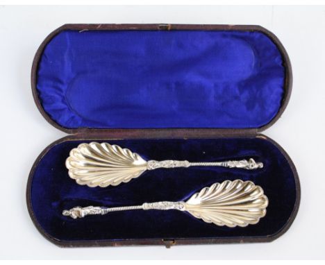 WILLIAM HUTTON & SONS; a pair of Victorian hallmarked silver apostle finial serving spoons with gilt washed scallop moulded b