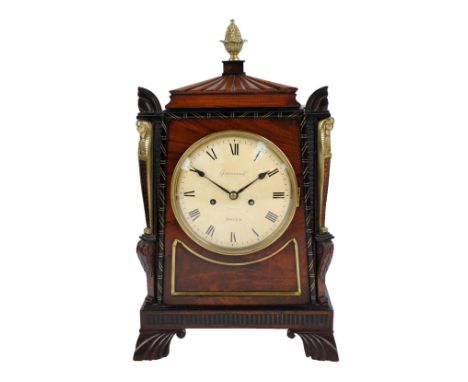 A Regency Egyptian Revival bracket clock, the brass pineapple finial above fluted canopy, the circular dial inscribed 'Greenw