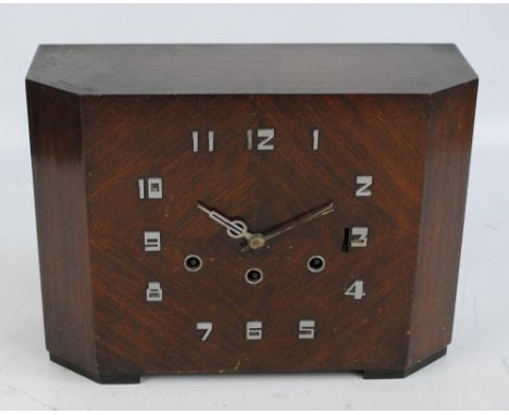 An Art Deco mahogany rectangular mantel clock with canted corners, with stylised chrome Arabic numerals and chiming movement,