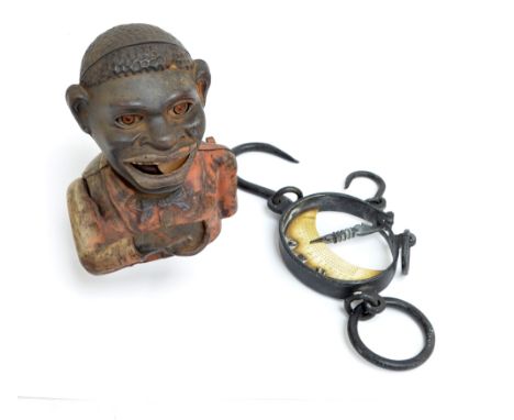 An American money bank and a set of hanging scales with brass crescent shaped delineated panel (2).