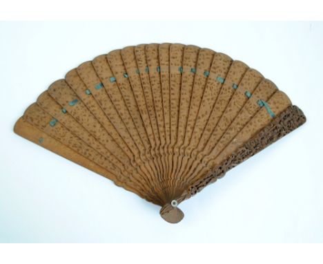 An early 20th century Chinese carved sandalwood brisé fan decorated with figural and architectural landscape and with foliate
