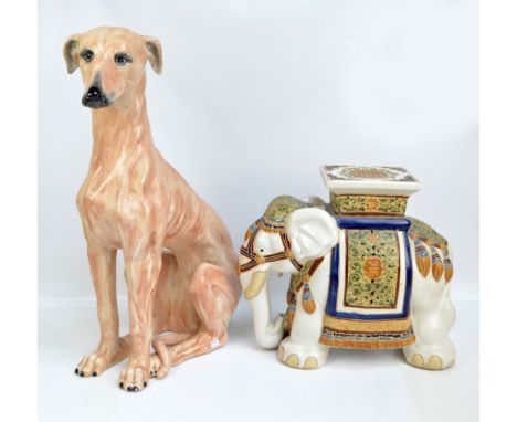 A very large ceramic model of a seated greyhound, height 74cm and a decorative ceramic seat in the form of an elephant with a