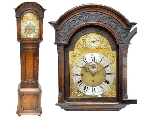 A 1920s oak longcase clock, the arched brass dial set with 'Whittington/Westminster Chime' above silvered chapter ring, subsi