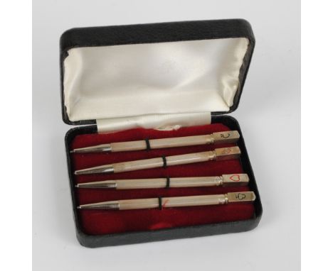 A cased set of four sterling silver engine turned decorated propelling pencils with card suit finials, length 8.5cm.