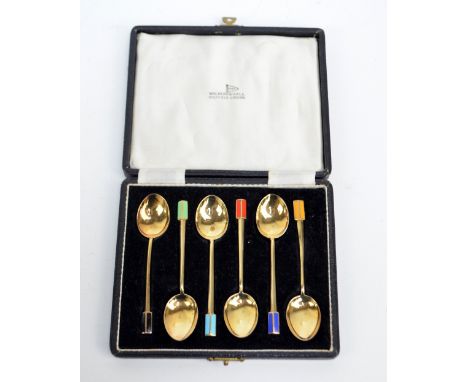 TURNER & SIMPSON; a cased set of six George V hallmarked silver gilt Art Deco style coffee spoons, each with variously colour