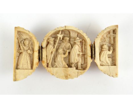 An unusual 19th century carved ivory travelling triptych altar modelled as a nut, the twin hinged section enclosing figural s