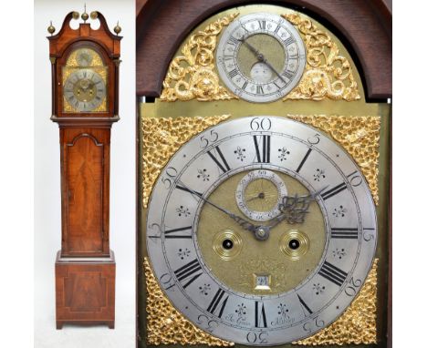 A 19th century mahogany and inlaid eight day longcase clock, the hood with broken swan neck pediment above arched brass dial,