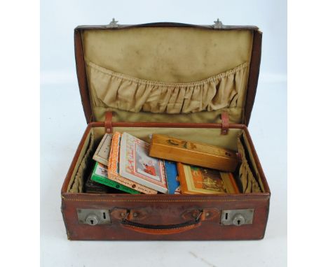 A quantity of collectors' items including a commemorative wooden pencil case, a tin of dominoes, some boxed games and puzzles