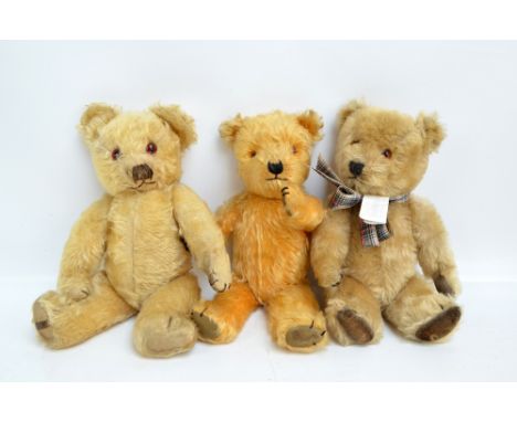 Three jointed mohair teddy bears, the longest with centre seam, orange and black glass eyes, stitched nose and mouth, brown v