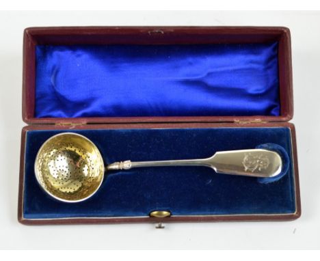 VASILY M ASHMARIN; a late 19th century Russian silver sifting spoon with gilt washed circular bowl and cast bird's foot decor