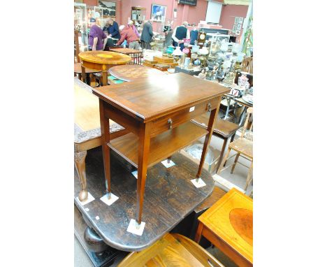 An Edwardian mahogany rectangular card table with single drawer above a shelf, on square tapering legs to square peg feet, wi