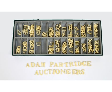 A collection of late 19th century carved ivory letters.