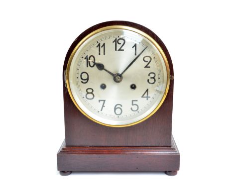 An early 20th century mahogany dome top mantel clock with silvered dial set with Arabic numerals, height 31cm.