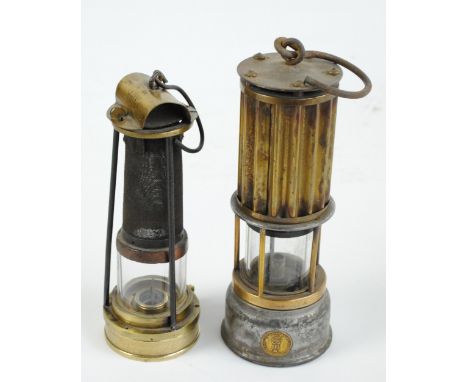 An early 20th century T. Mills of Newcastle brass miner's safety lamp, height 23cm and a further example by Engineering Co Lt