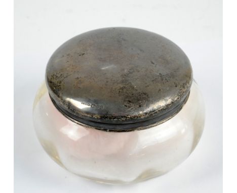 J & R GRIFFIN LTD; a large George V hallmarked silver topped clear glass dressing table power jar, initialled M to the detach