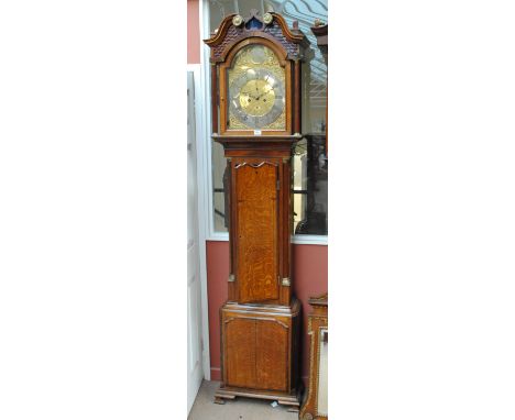 A 19th century oak and mahogany crossbanded longcase clock, the broken swan neck pediment above arched brass dial inscribed '