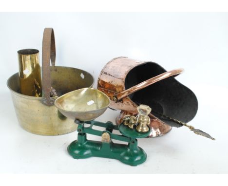A quantity of copper and brassware to include a copper coal scuttle, a brass teapot, coal bucket, ammunition shell, etc. 