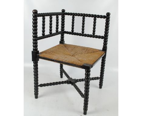 A late 19th century ebonised bobbin turned rush seated corner chair, 41 x 41cm.