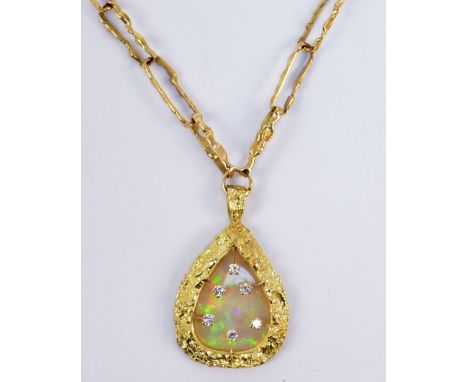 A 14ct yellow gold textured long open link chain supporting a gold, opal and diamond nugget shaped pendant, the pear shaped o