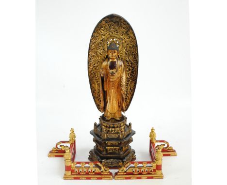 A Japanese Edo period gilt carved wood statue of Buddha Amida Nyorai underneath a cloud motif decorated mandorla on double lo