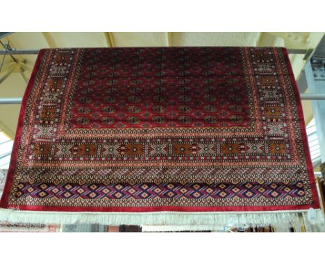 A red ground Bokhara carpet, 280 x 200cm.