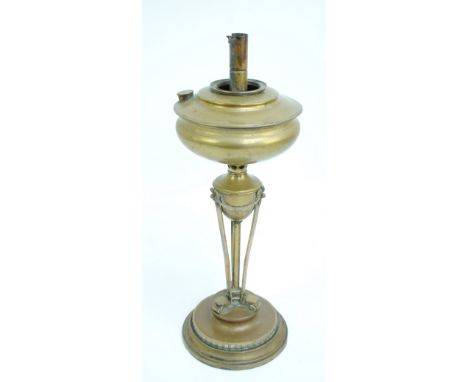 A late Victorian brass oil lamp for restoration, lacking screw upper section and raised on a tapering central column to sprea