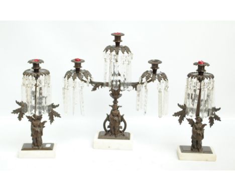 A spelter candlestick lustre garniture comprising three branched candlestick with figural base and a pair of similar single b