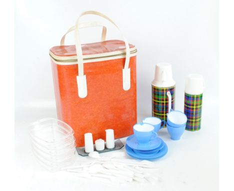 A vintage four setting picnic set to include two Vacco thermos, teacups, plates and saucers, etc in acrylic hamper. 