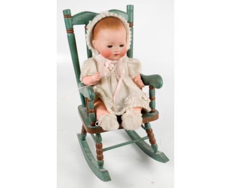 An Armand Marseille bisque headed doll with open and close eyes, open mouth with two teeth, composite body and limbs, stamped