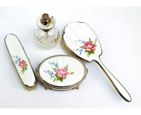 ADIE BROS; an Elizabeth II hallmarked silver and enamel decorated four piece dressing table set decorated with floral sprays,