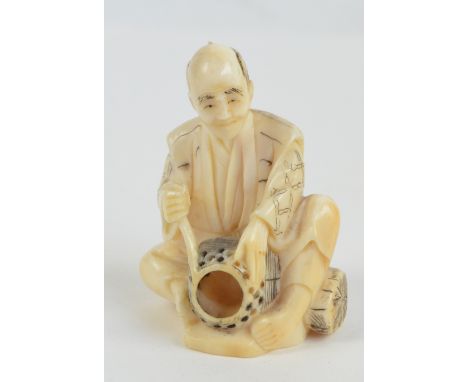 A Japanese Meiji period carved ivory netsuke of a seated basket maker, scratched two character mark signature to base, height