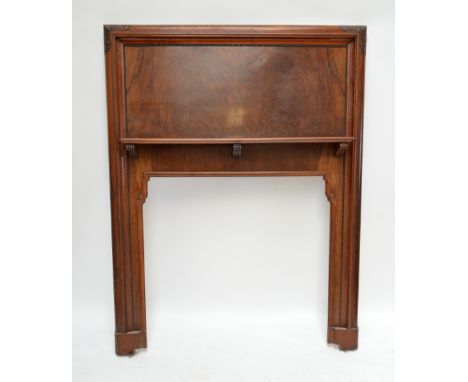 A 20th century walnut fire surround with carved corners to the architrave, beading detailed shelf with shaped opening, width 