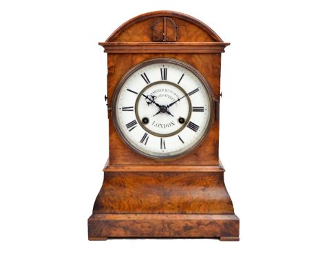 CAMERER KUSS & CO; a 19th century burr walnut cuckoo mantel clock with arched top and ogee plinth to small square feet with c